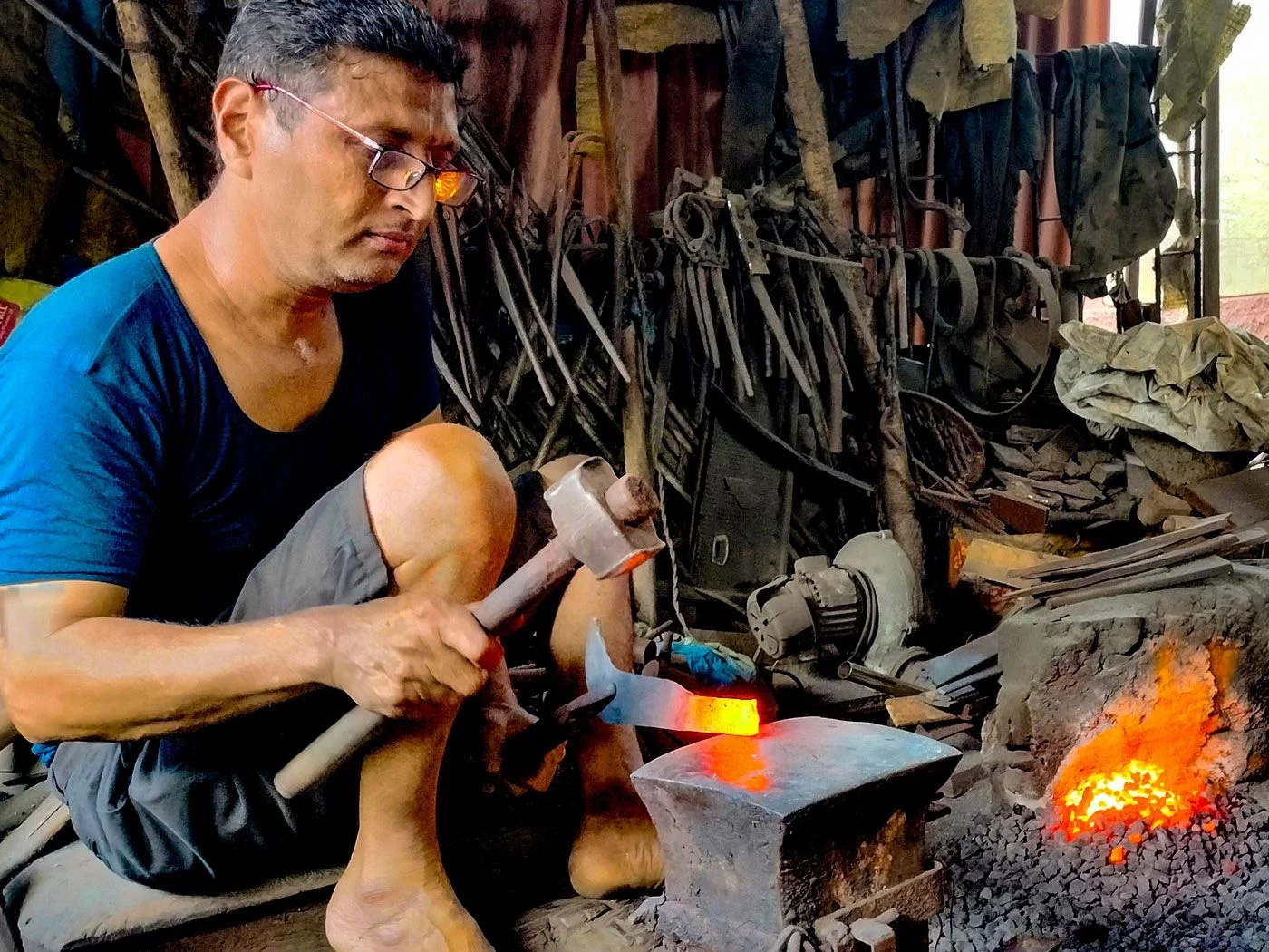 PM Vishwakarma Yojana - blacksmith artisan working with traditional tools